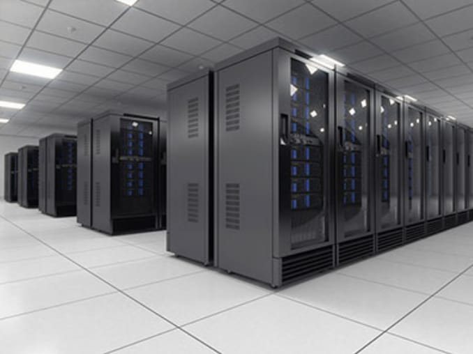 A row of enclosed network cabinets built out for a corporate server room, with equipment mounted, powered and cabled for data and voice.